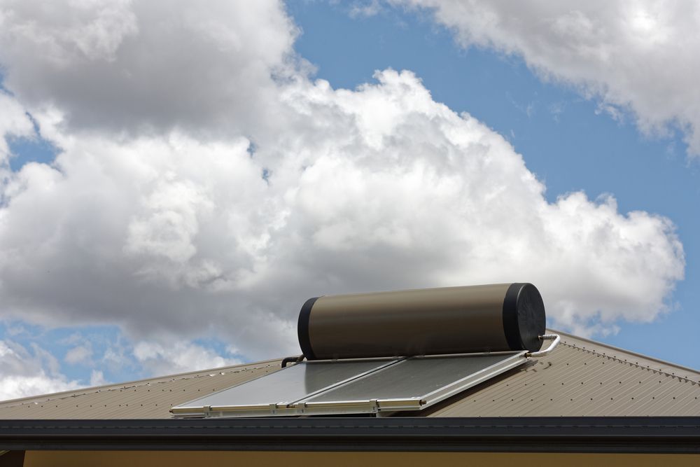 Solar Water Heater on a Roof Against a Cloudy Sky — Taps 'R' Us in Mountain Creek, QLD