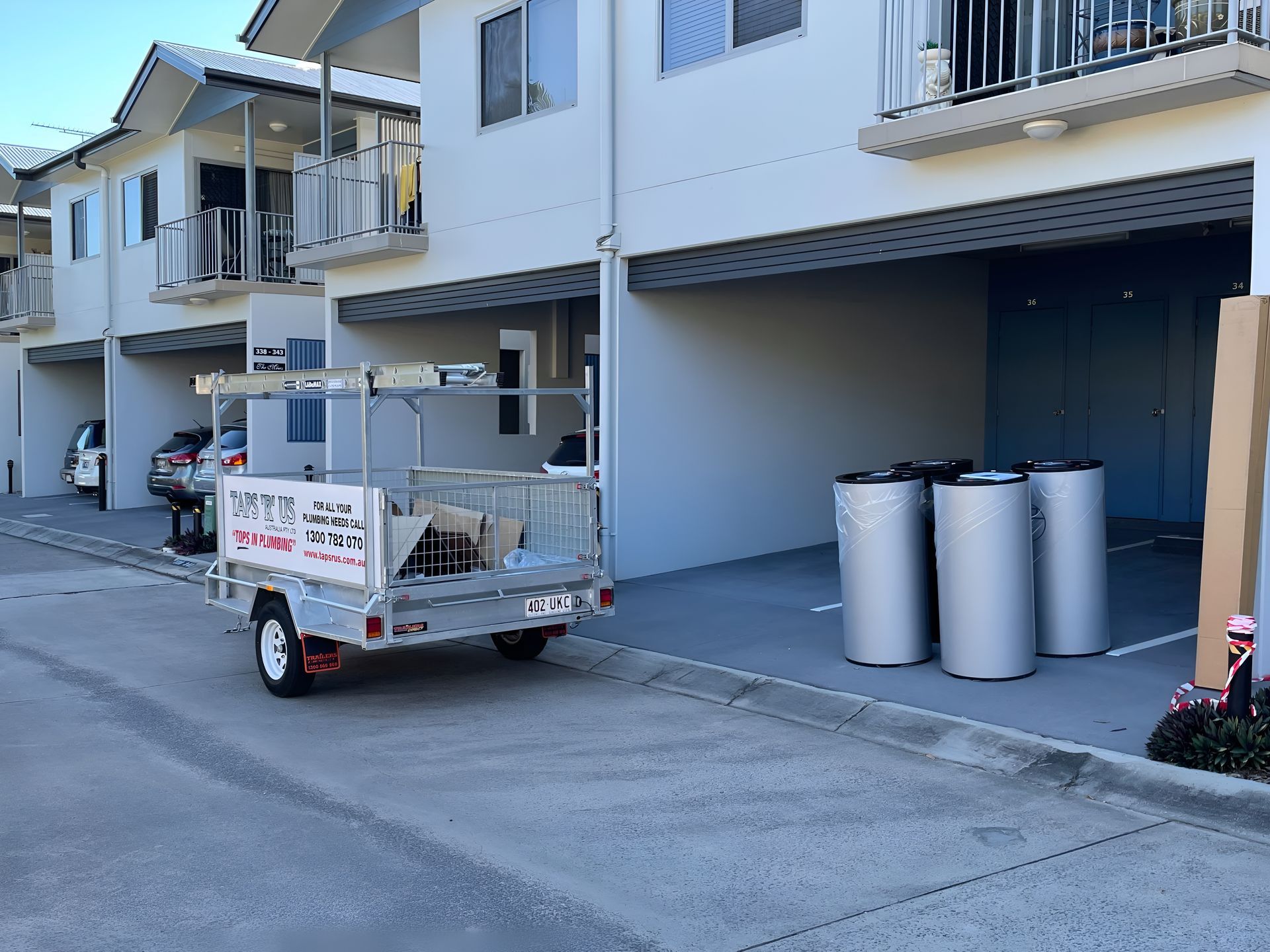 Trailer With Equipment Parked Near Townhouses — Taps 'R' Us in Palmview, QLD