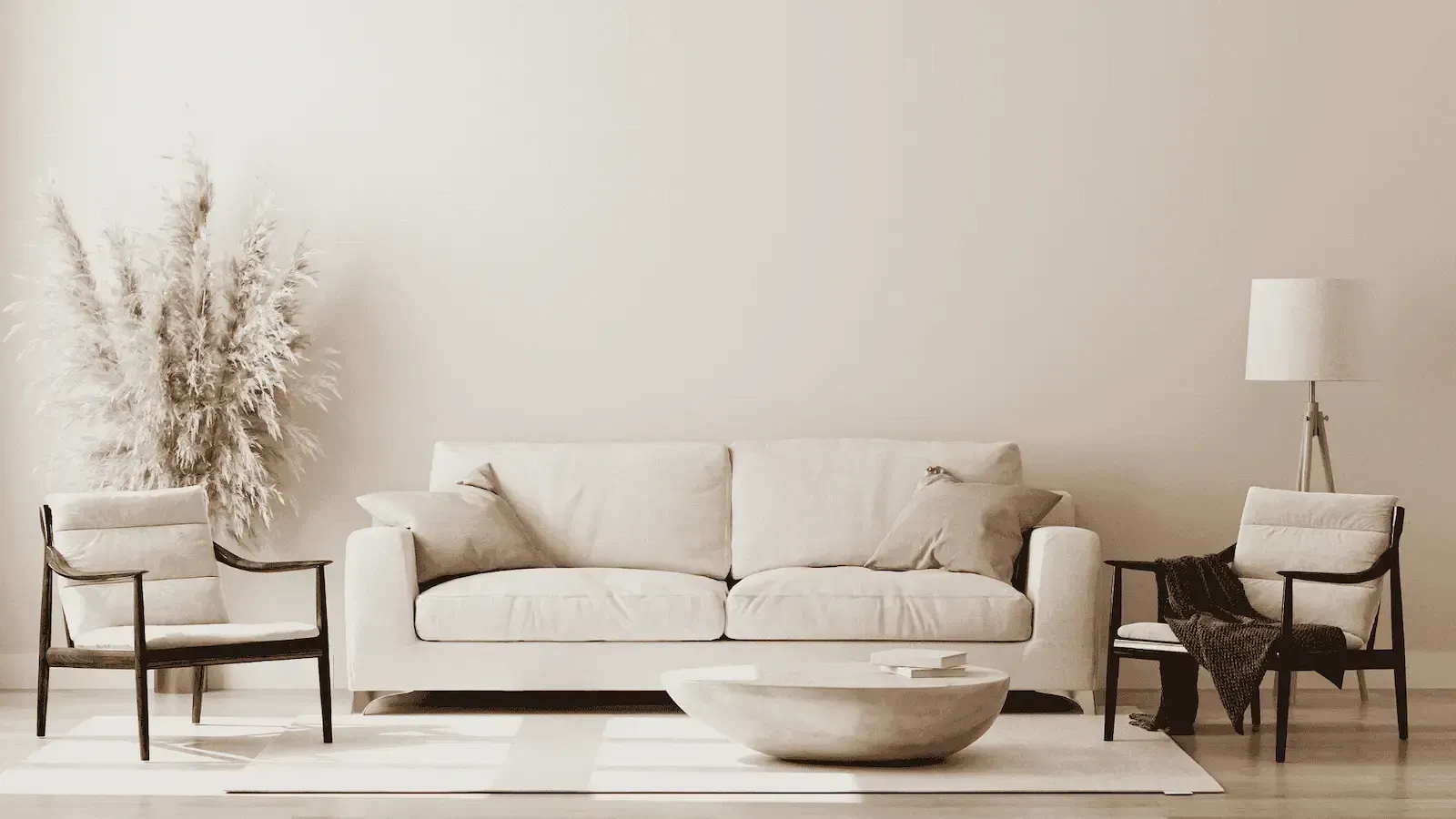 A living room with a white couch , chairs , coffee table and lamp.