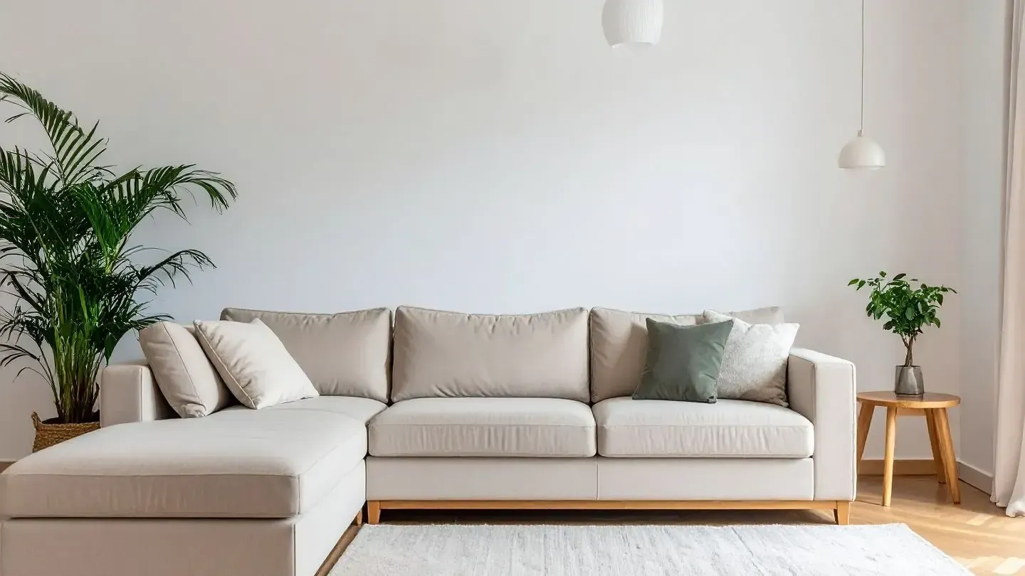 Minimalist living room with a large light beige sectional sofa.