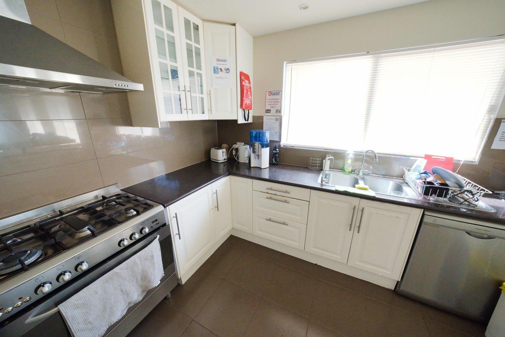 A kitchen with a stove , sink , and dishwasher.