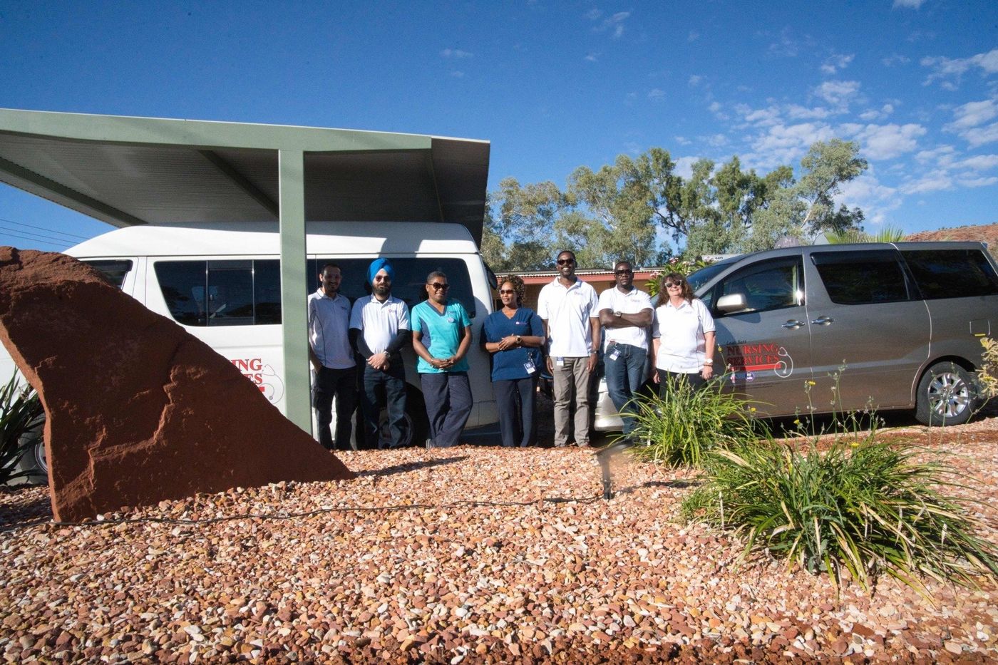 A group of people standing in front of a van