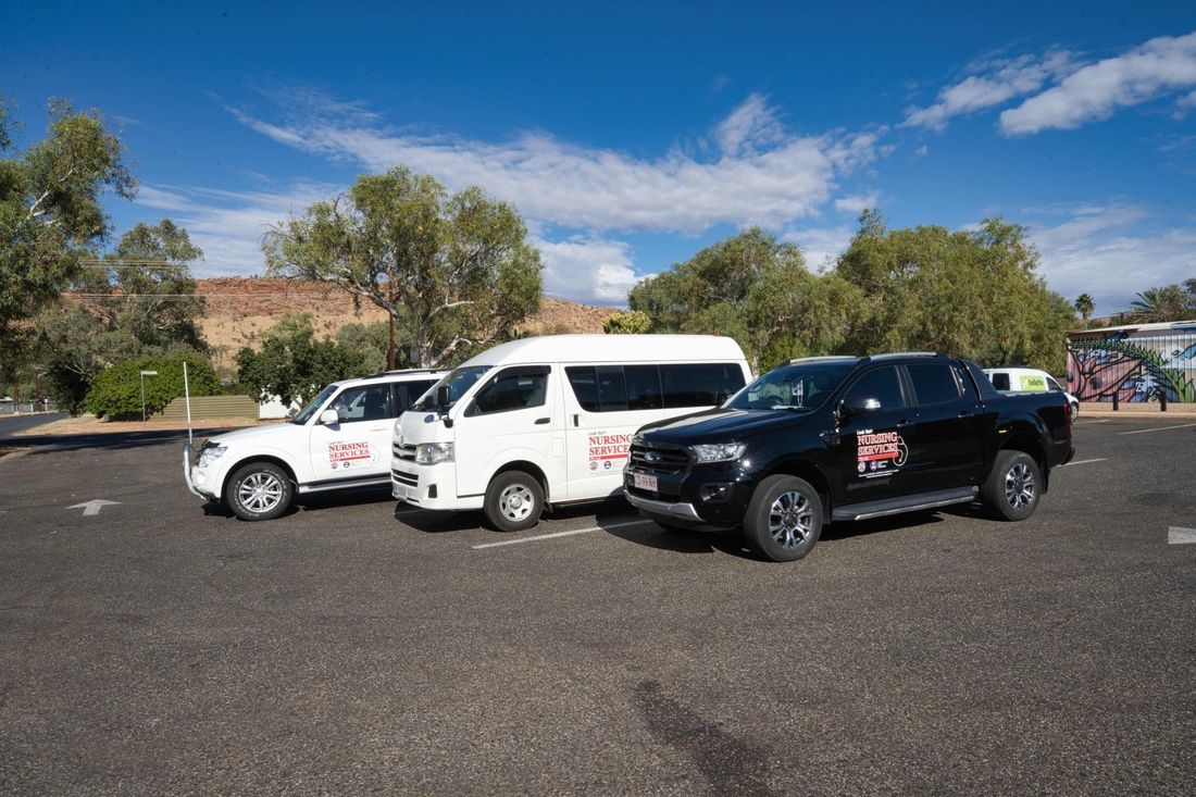 Three vehicles are parked next to each other in a parking lot.