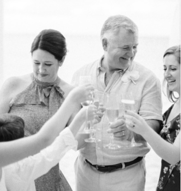 A group of people are toasting with wine glasses