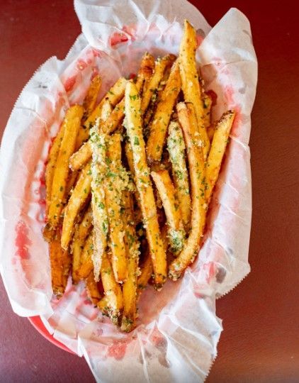 A basket of french fries on a red plate