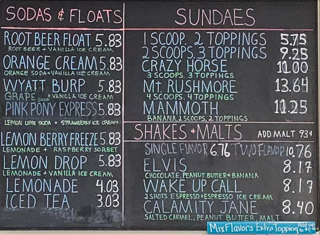 A chalkboard menu for sodas and floats and sundaes