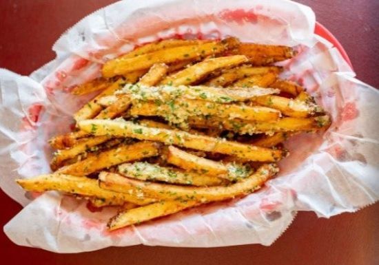 A basket of french fries on a red plate