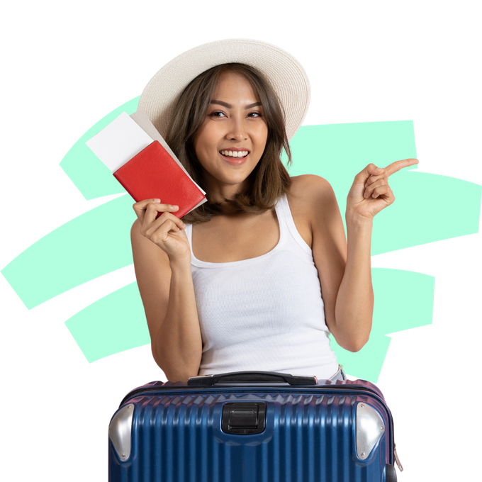 A woman is sitting on a suitcase holding a passport and pointing.