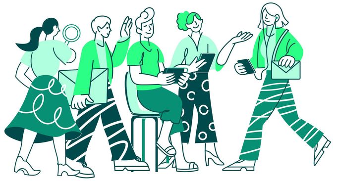 A group of people are standing around a table talking to each other.
