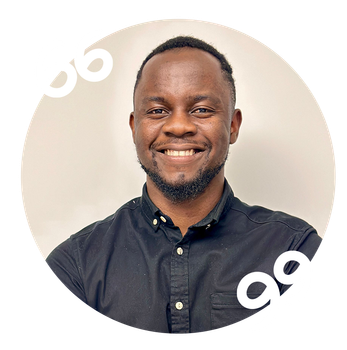 A man in a black shirt is smiling in a circle.
