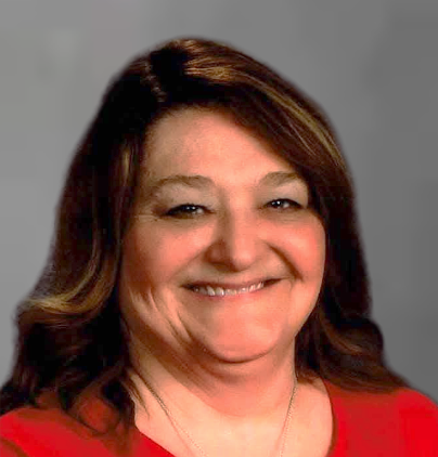 Smiling woman with long brown hair against a gray background