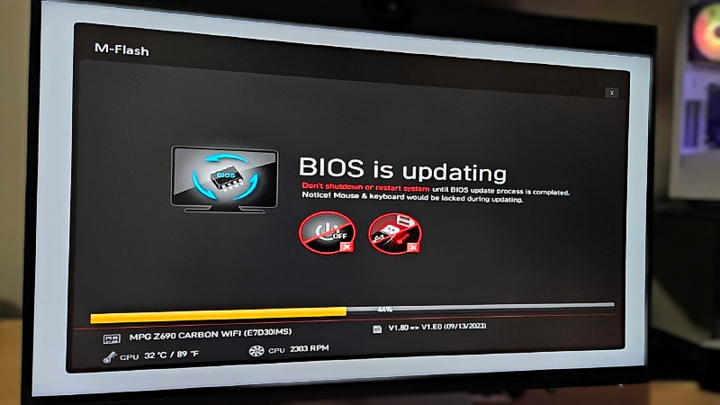 A computer monitor is showing that the bios is updating.