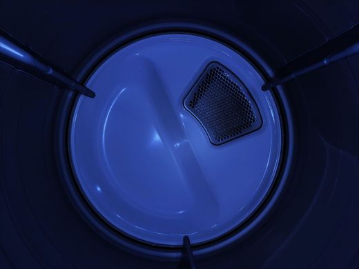 Blue plastic container interior with a circular base and a small grated vent near the edge