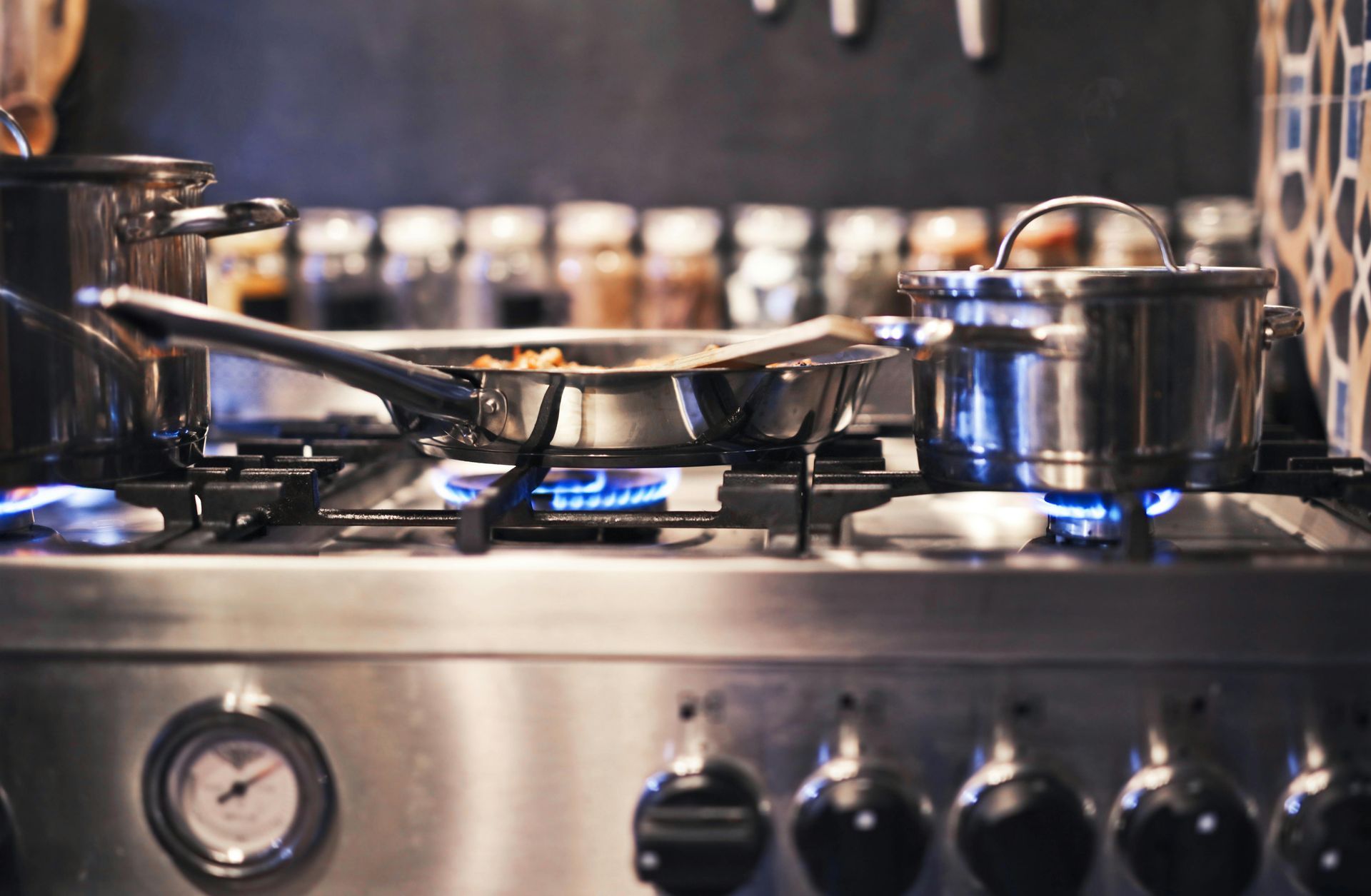 a gas stove top with pots and pans on top