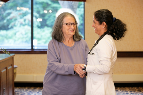 A resident and caregiver together at AristaCare at Cedar Oaks in South Plainfield