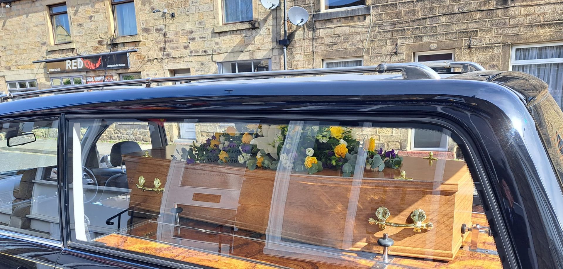 A coffin is sitting in the back of a car.