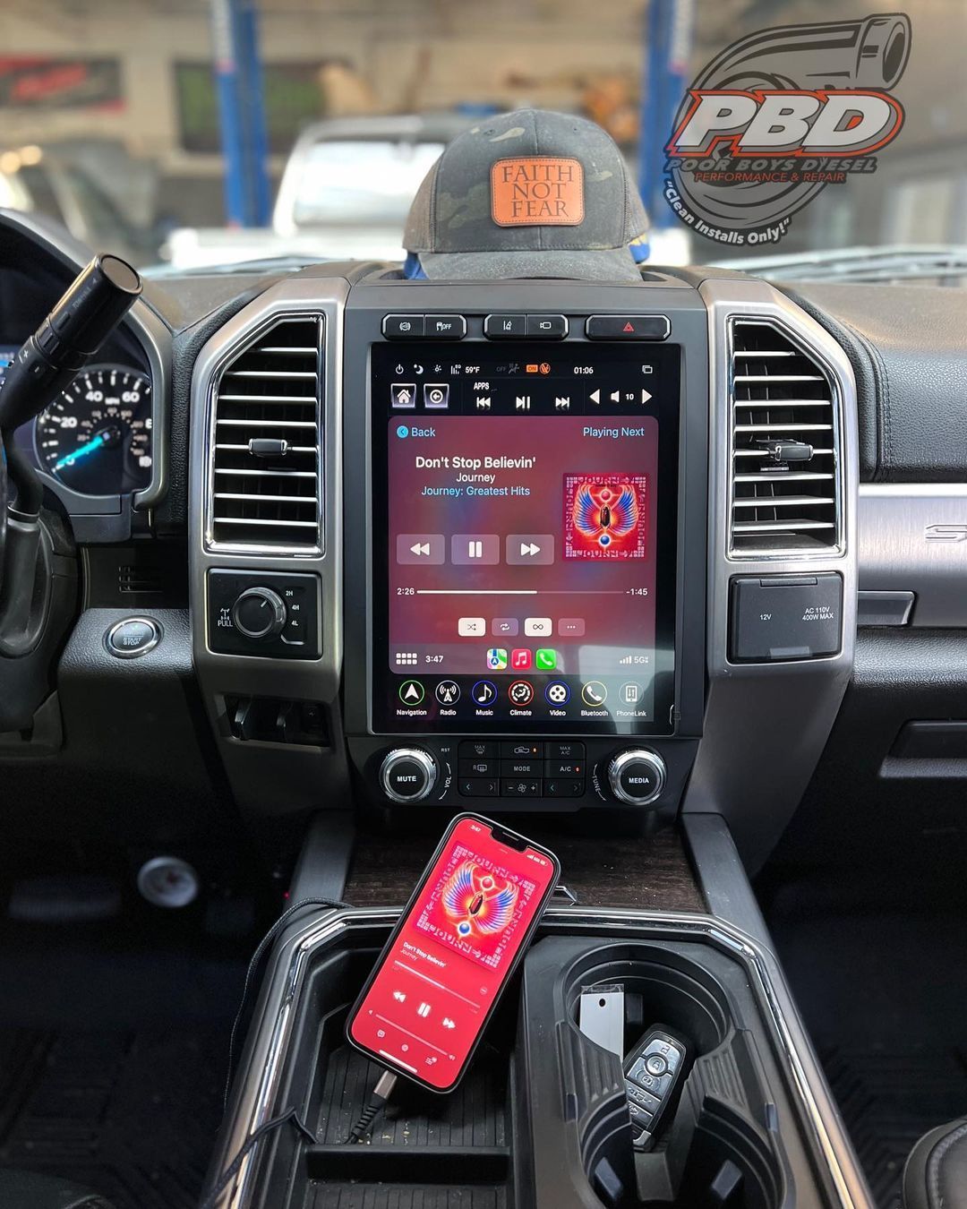 A cell phone is plugged into the dashboard of a truck.