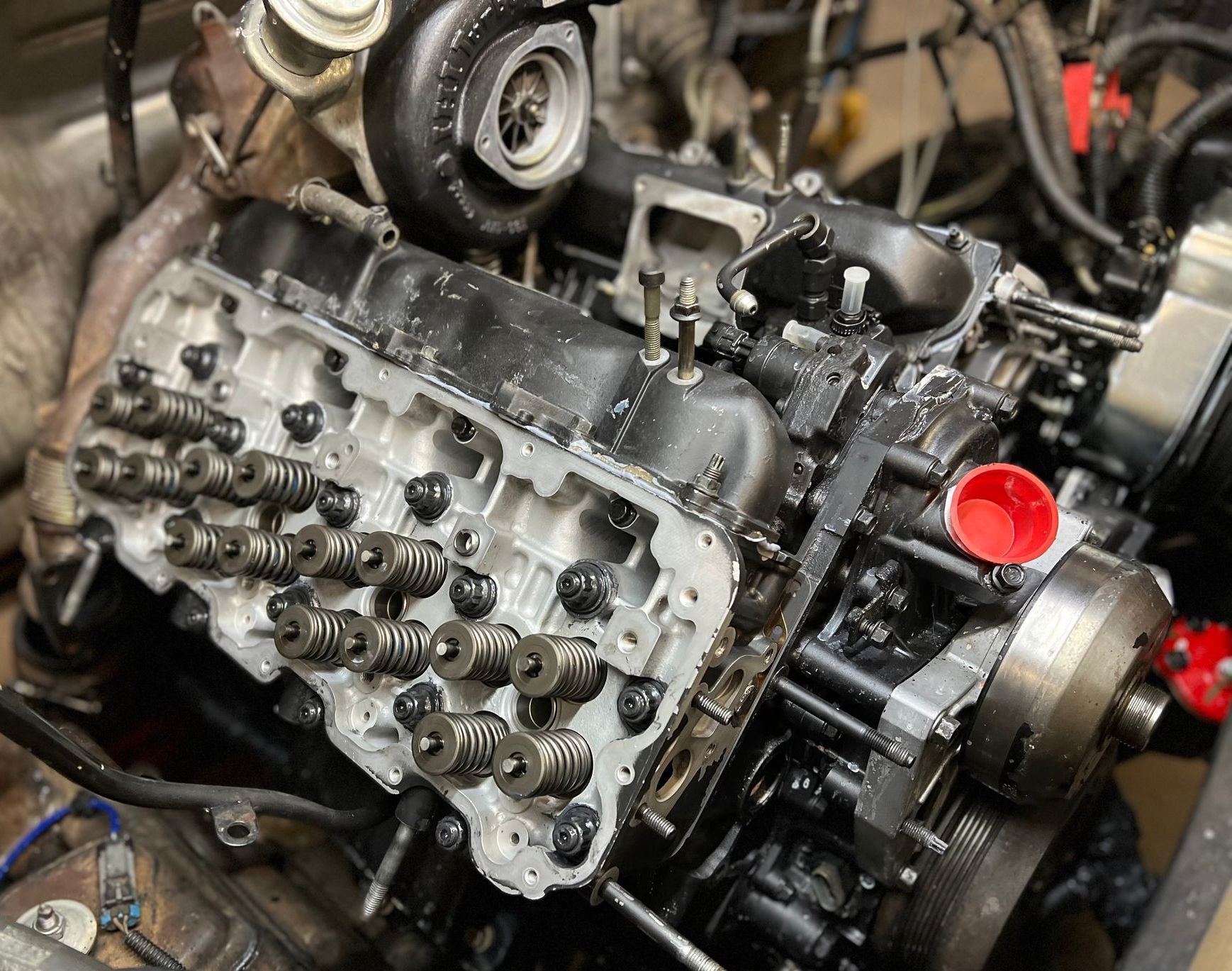 A close up of a car engine being worked on.