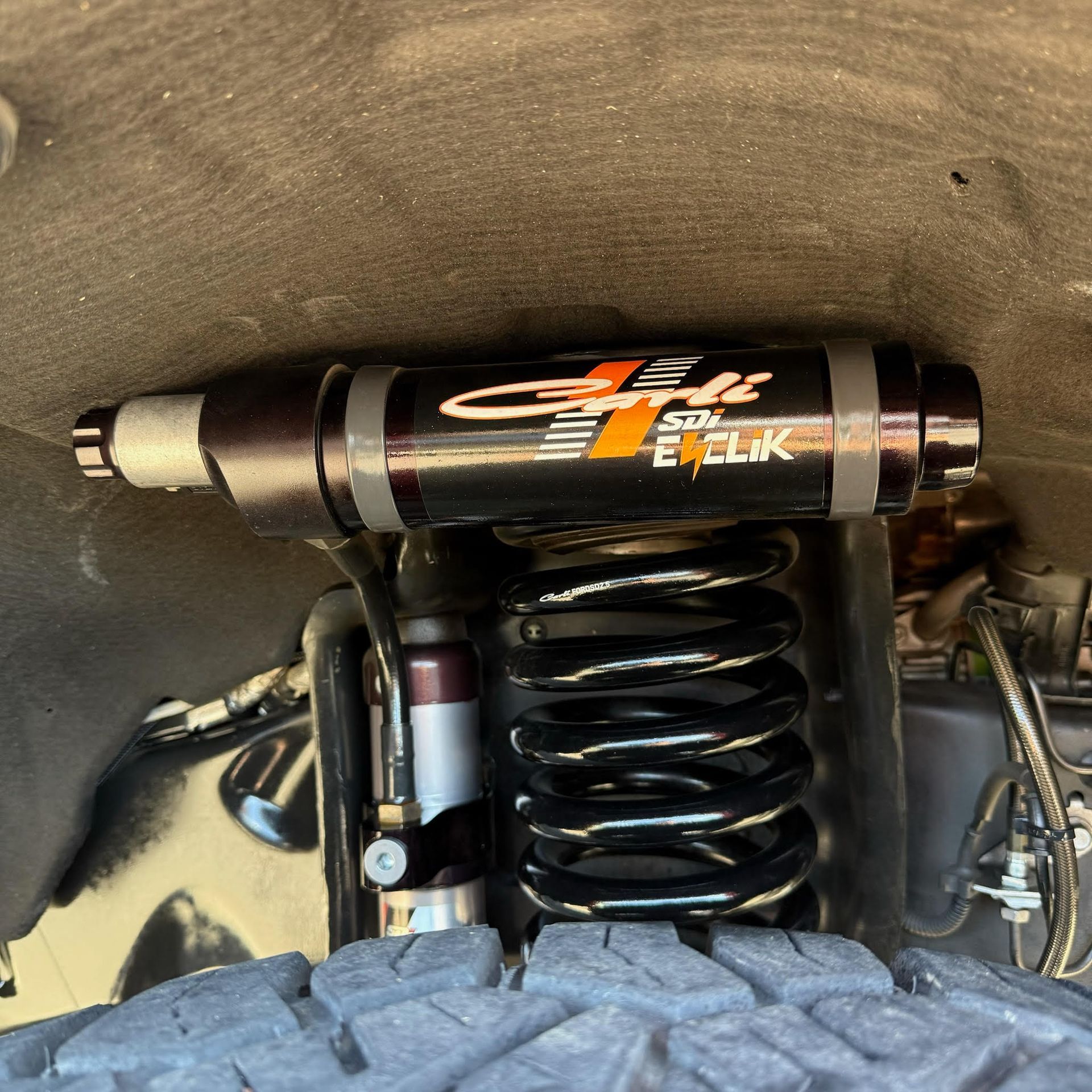 A close up of a shock absorber on a vehicle