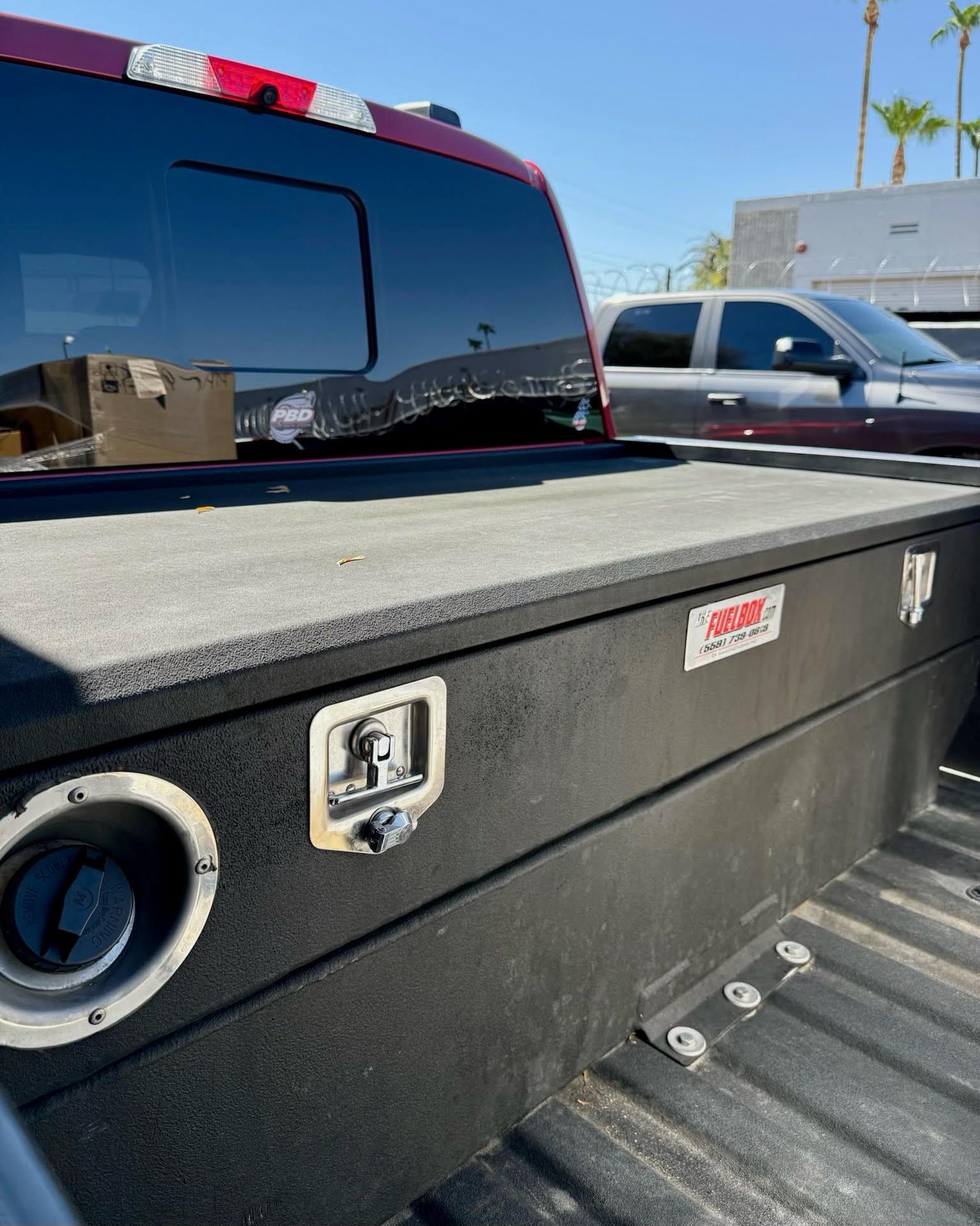 The back of a truck with a toolbox in the bed.