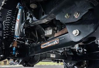 Black truck suspension with blue shock absorber and 