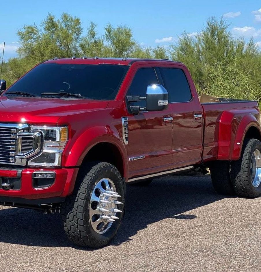 A red truck is parked on the side of the road