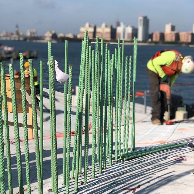 A man is working on a construction site near the water