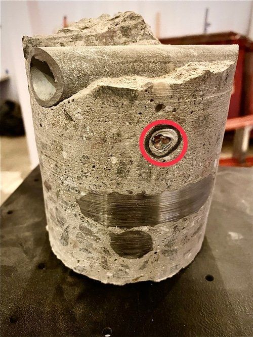 A piece of concrete with a hole in it is sitting on a table.