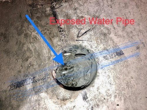 A close up of a water pipe with an arrow pointing to it.
