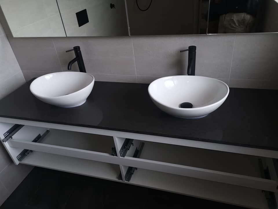 A Bathroom With Two Sinks And A Mirror —  RAW Plumbing & Gasfitting In Pearce, ACT