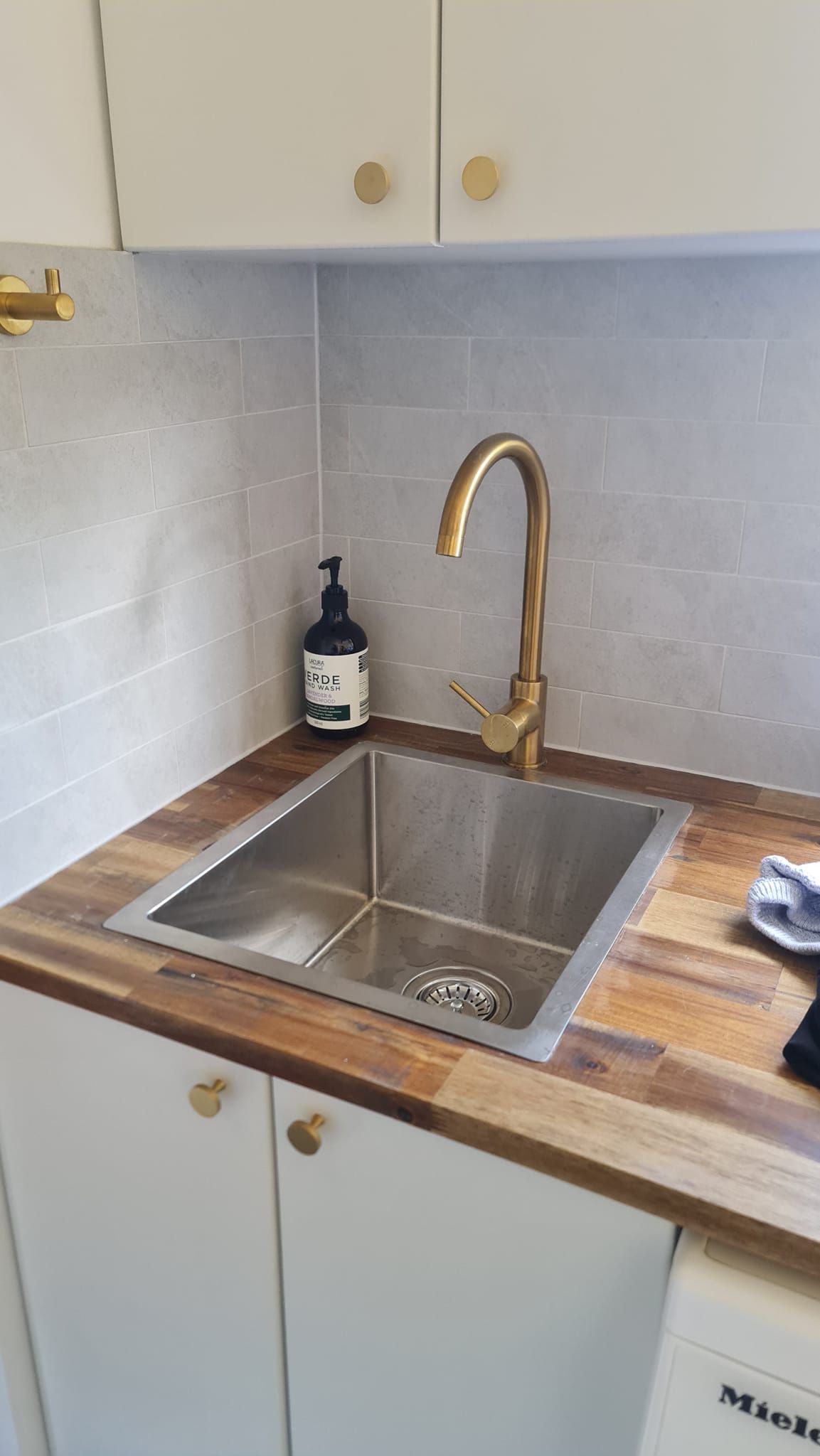 A Kitchen Sink With A Brass Faucet On A Wooden Counter Top — RAW Plumbing & Gasfitting In Pearce, ACT