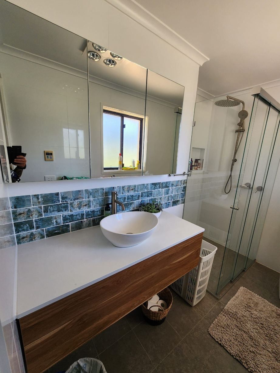 A Bathroom With A Sink , Mirror And Shower — RAW Plumbing & Gasfitting In Pearce, ACT