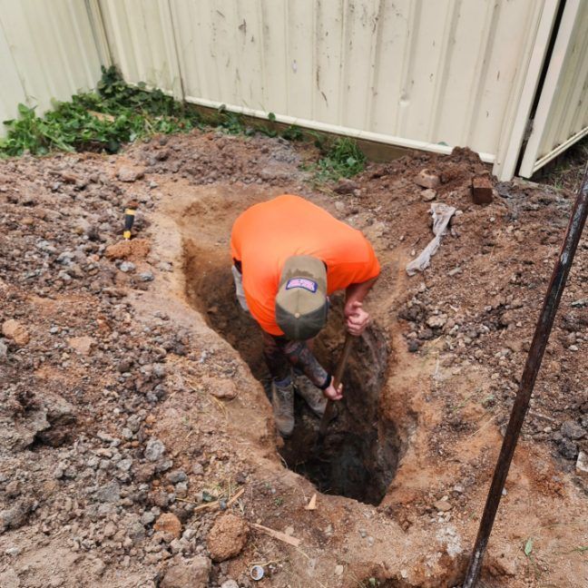 A Man Is Digging A Hole In The Ground With A Shovel —  RAW Plumbing & Gasfitting In Pearce, ACT