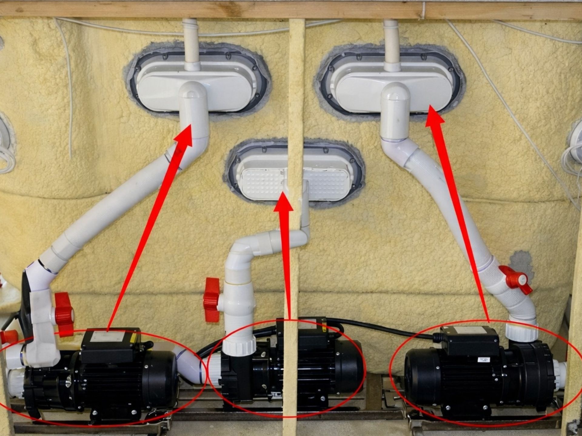 Internal plumbing view of a swim spa showing three separate pumps, each assigned to a specific function, ensuring stable water flow, efficient performance, and reduced system overload.