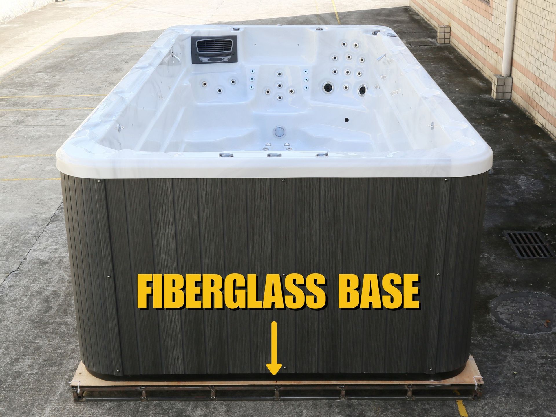 Front view of an above-ground swim spa highlighting the reinforced fiberglass base, designed to provide strong structural support, moisture protection, and long-term durability for outdoor installation.