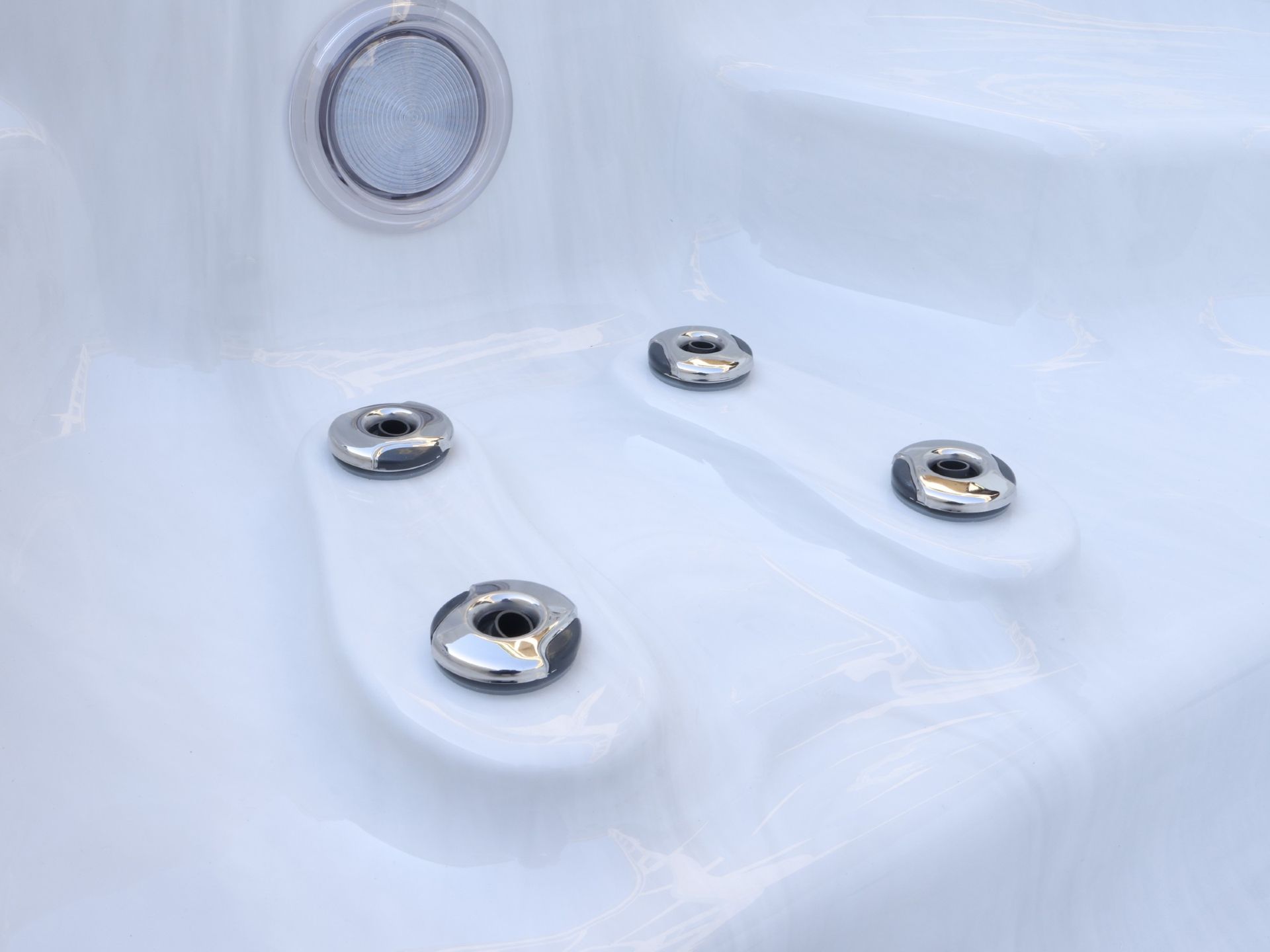 Close-up of stainless steel foot massage jets inside a swim spa, designed to deliver targeted hydrotherapy for feet and lower legs, improving circulation and relieving muscle fatigue.