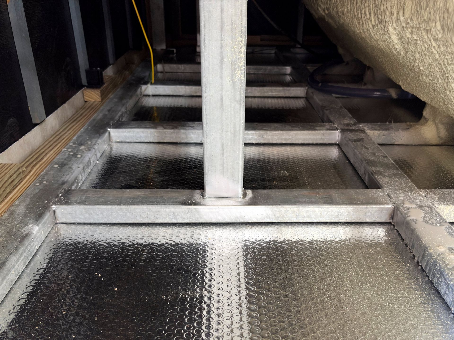 Galvanized steel frame structure supporting an above-ground swim spa, designed for high load strength, durability, and long-term outdoor installation.