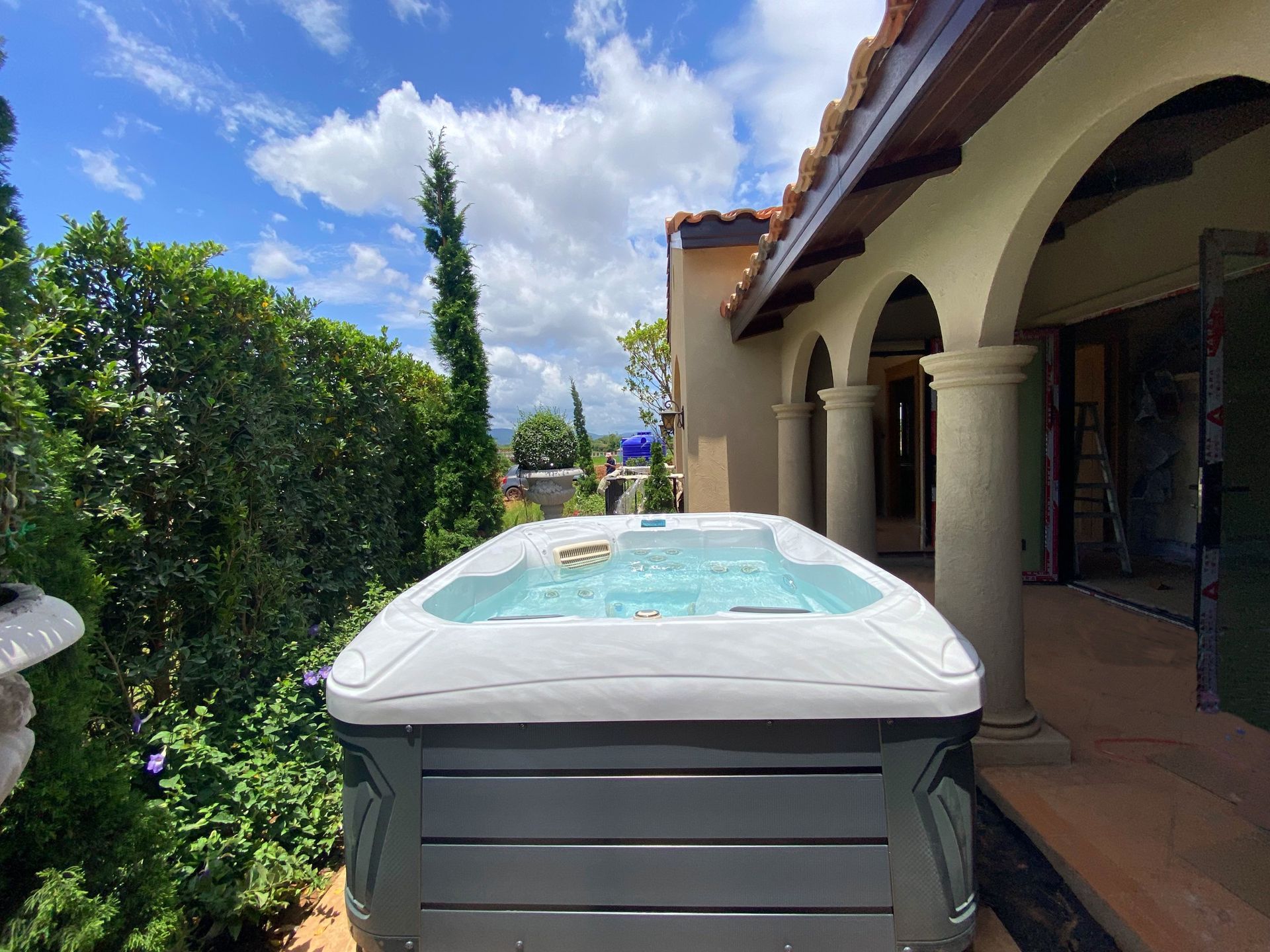 Q&G outdoor hot tub nestled in a side garden area with greenery in Pakchong, Khao Yai