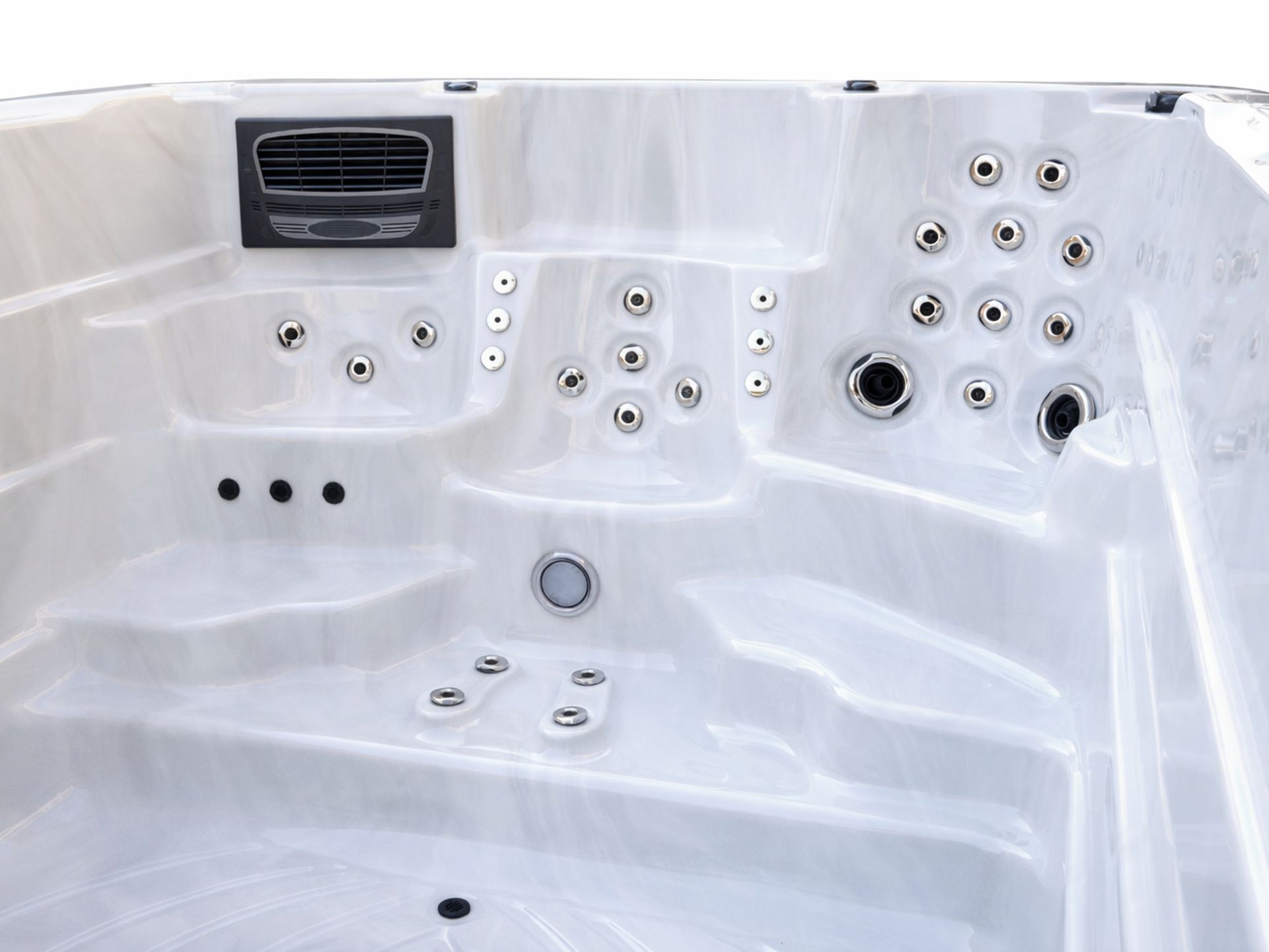 Interior view of a swim spa featuring an ergonomic hydrotherapy seating area with multiple massage jets for full-body relaxation and therapeutic use.