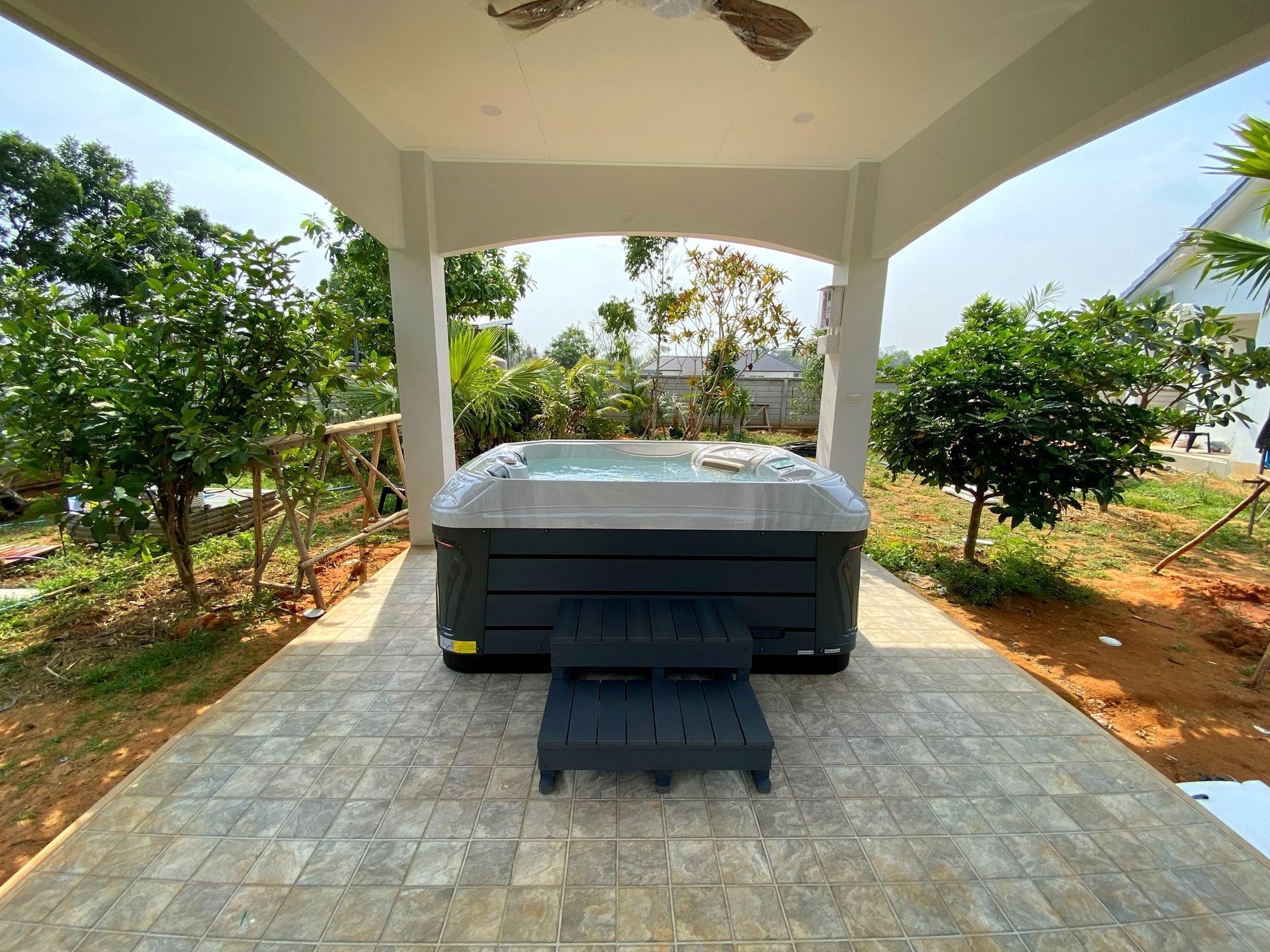 Q&G outdoor hot tub inside a garden spa pavilion surrounded by plants in Mueang Korat, Nakhon Ratchasima