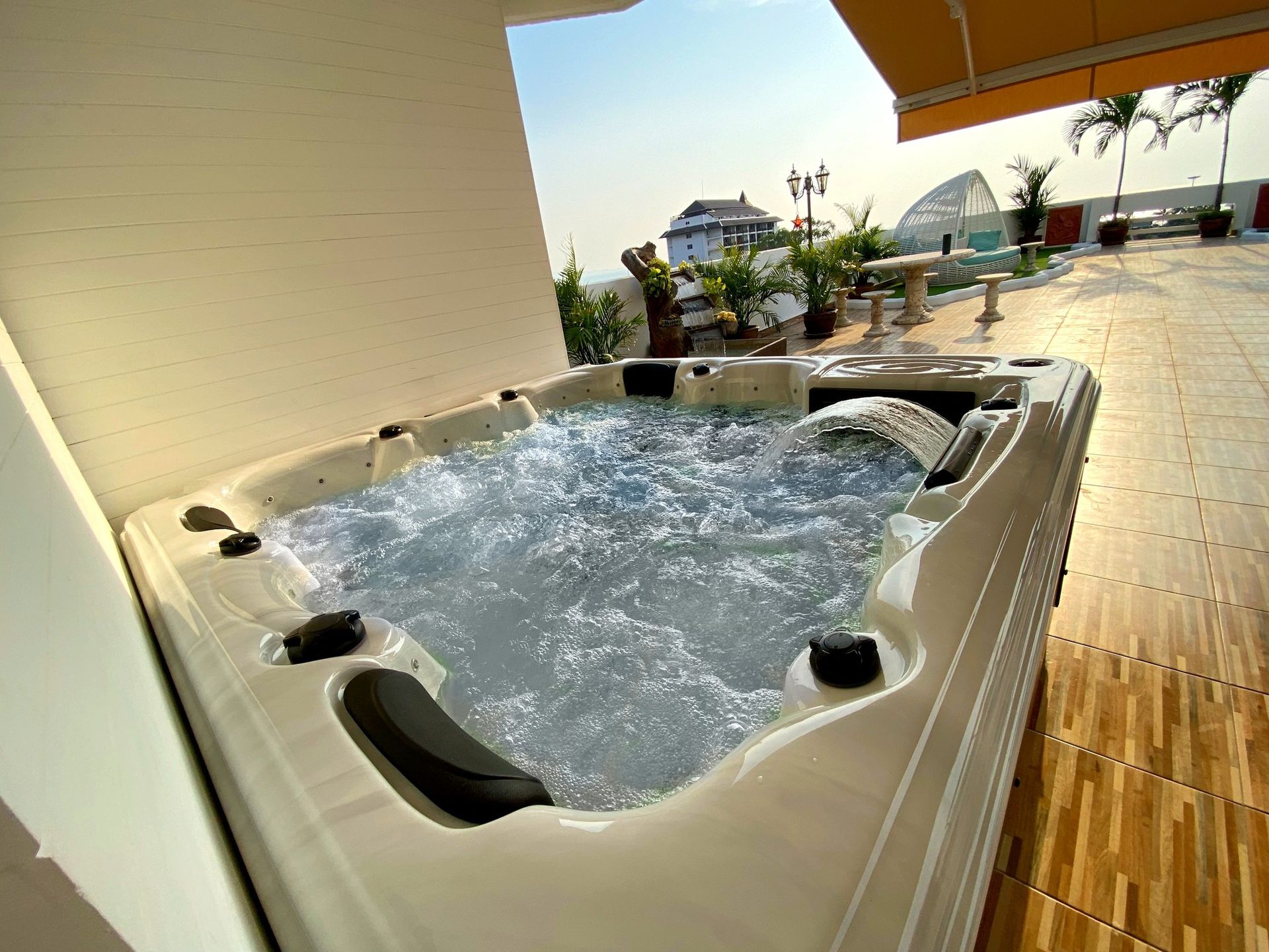 Q&G outdoor hot tub on a fourth-floor condo balcony in Pattaya with surrounding city views