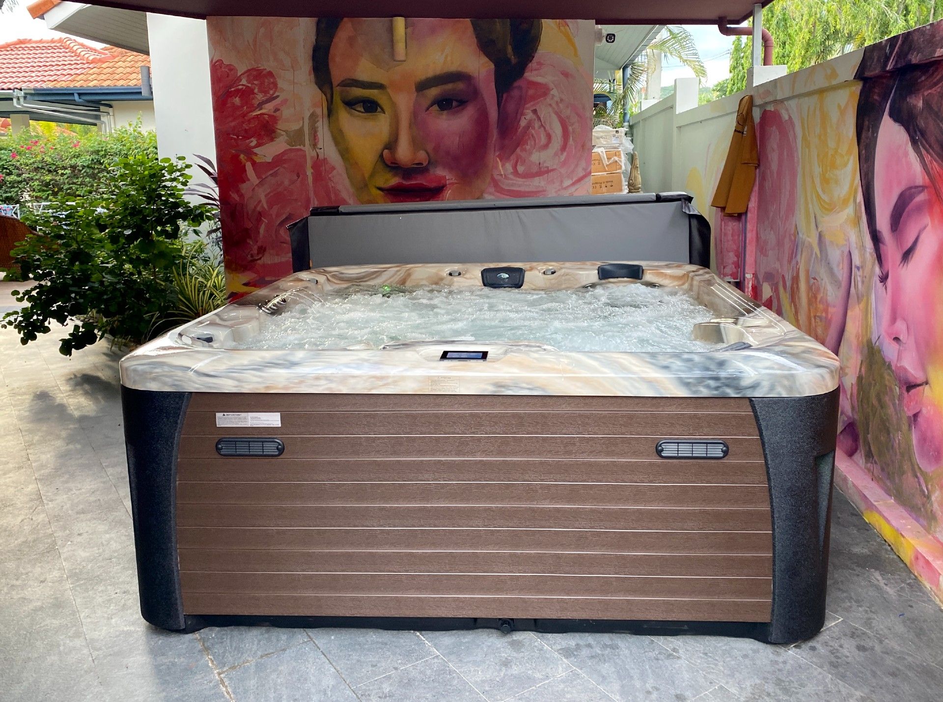 Q&G RAIN FOREST hot tub installed along the side of a house in Hua Hin, turning a narrow side yard into a colorful private spa corner