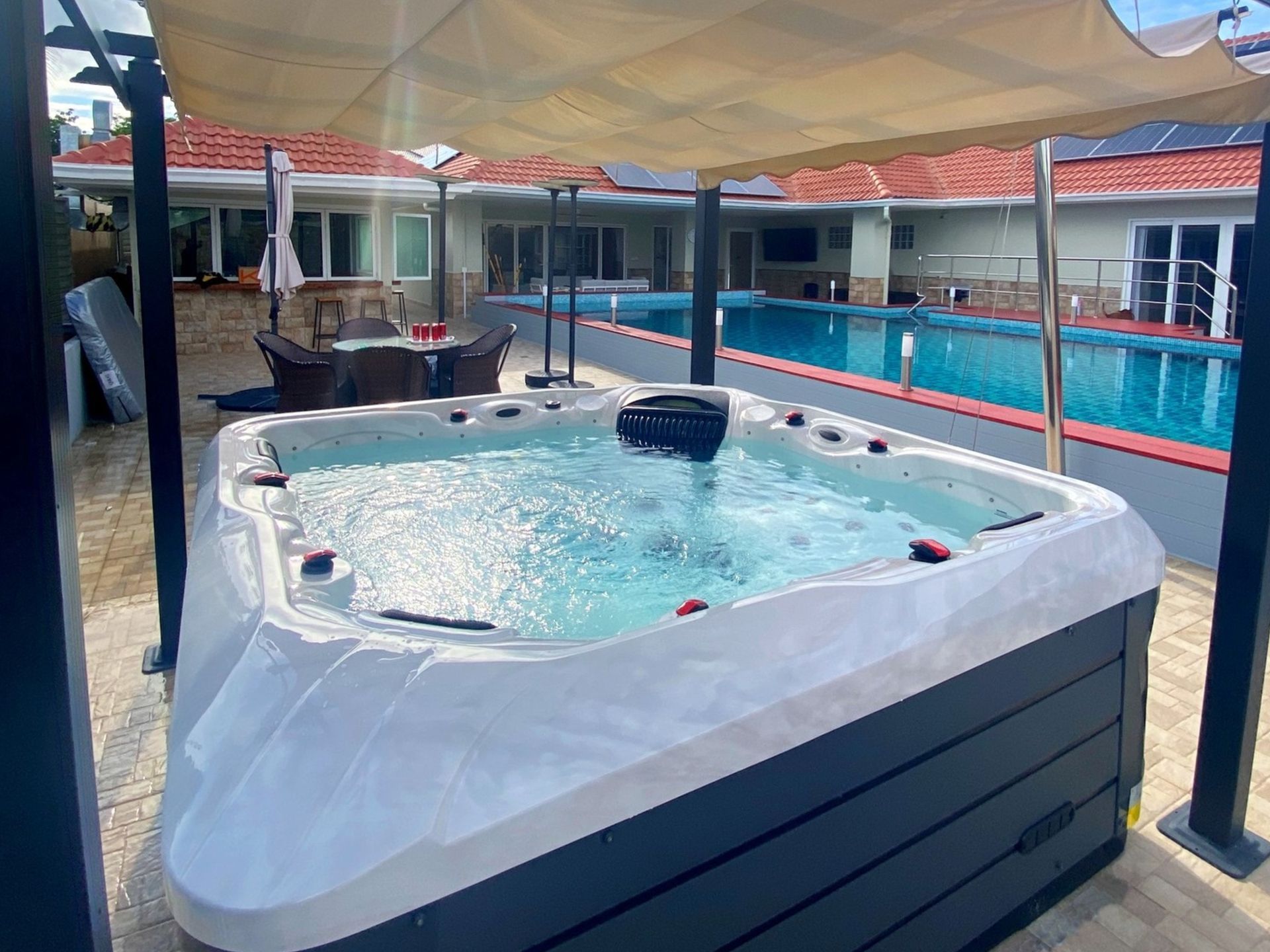 Q&G outdoor hot tub under a poolside pavilion next to a swimming pool in Pattaya, Banglamung
