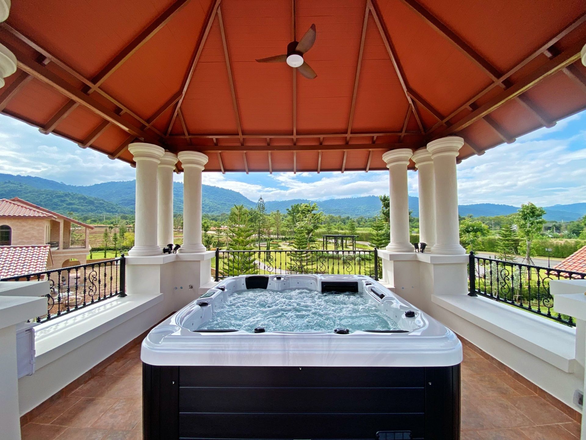 Q&G ADEN II outdoor hot tub installed in a landscaped garden seating area