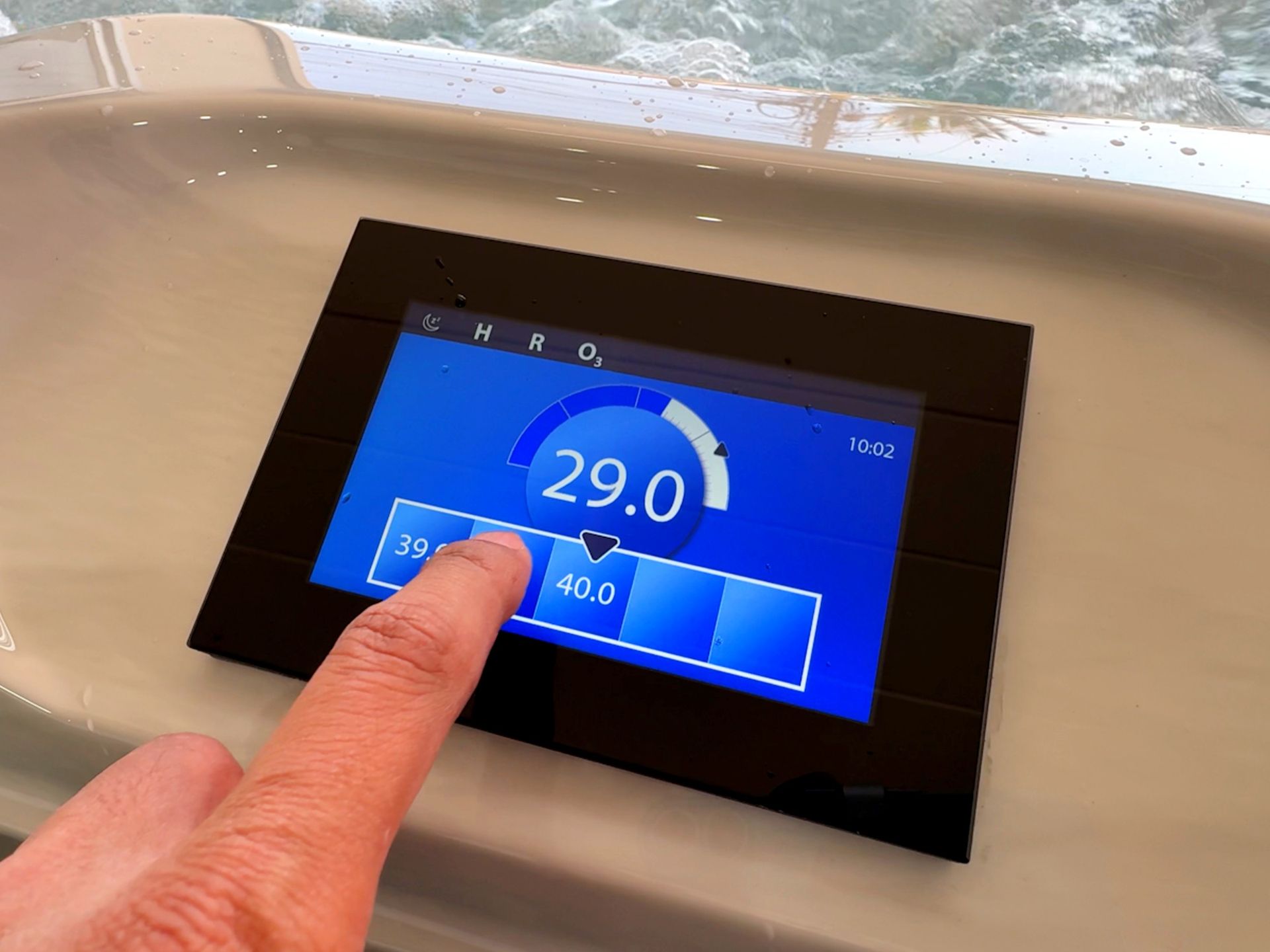 Touch screen panel showing adjusting the temperature of swim spa