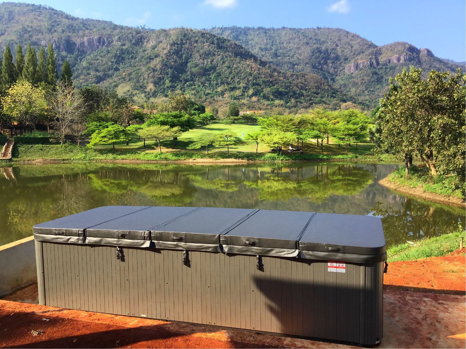 Swim spa fully covered with insulated hard cover for heat retention sun rain protection