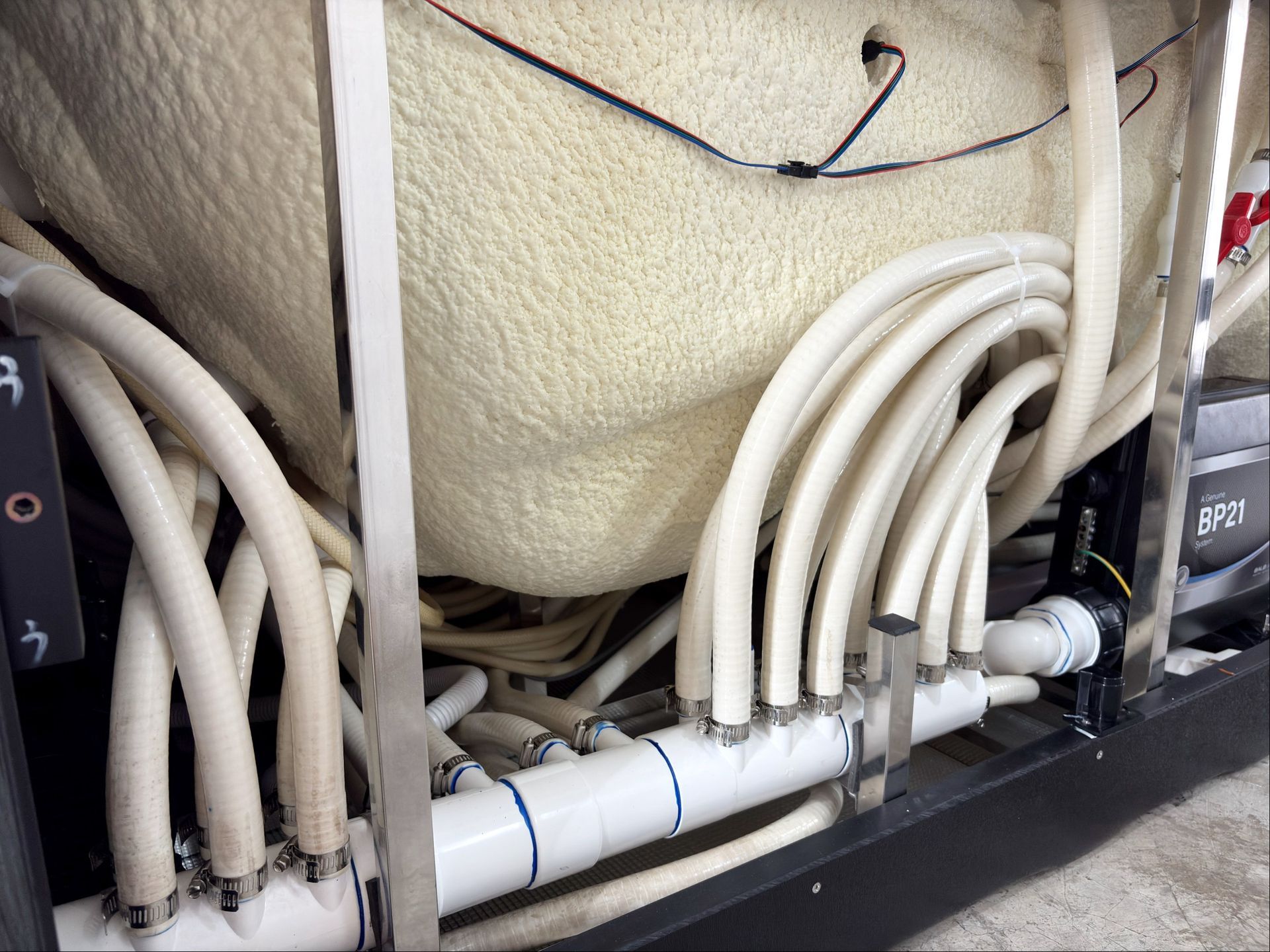 Close-up of outdoor hot tub plumbing system showing high-quality pipes and secure fittings for durability and long-term performance