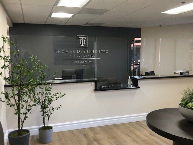 A thomas d bennetts sign is on the wall above the reception desk