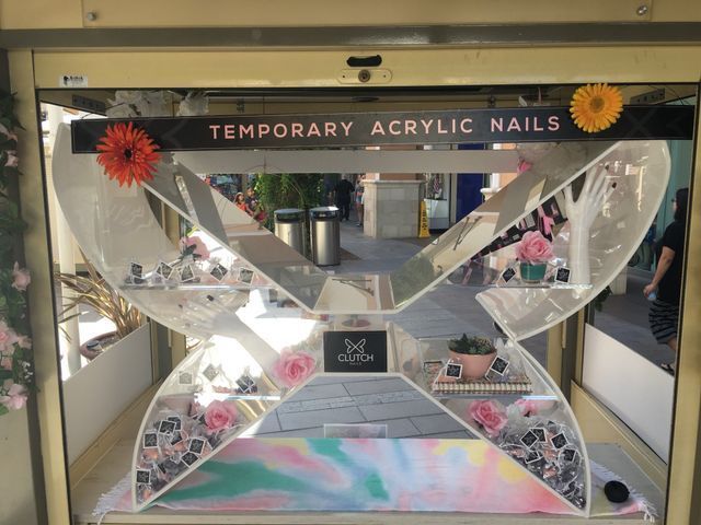 A display of temporary acrylic nails in the shape of a butterfly