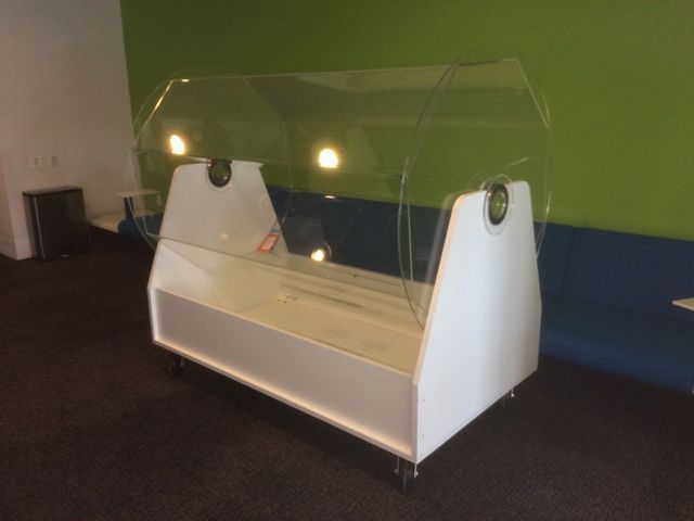 A white display case with a clear acrylic top